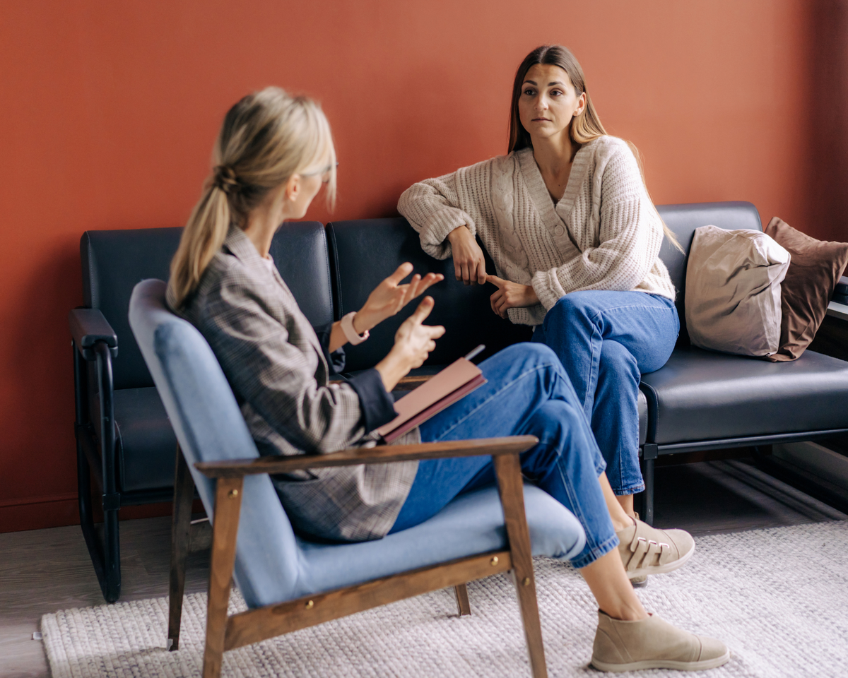 Naturopathic support from practitioner in a chair helping her client 